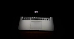 Macbook partially closed in the dark